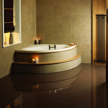 White acrylic corner bath by Tuskan Tiles, Aqua Lagoon Space Saver design, 1200 x 1200mm, shown in a modern bathroom setting.