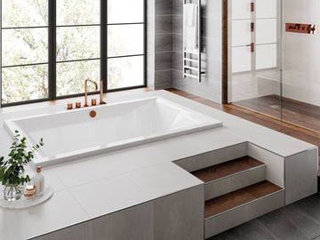 White Trojan Amare superdeep double-ended inset bath from Tuskan Tiles, measuring 1800x1200mm, shown in a modern bathroom setting.