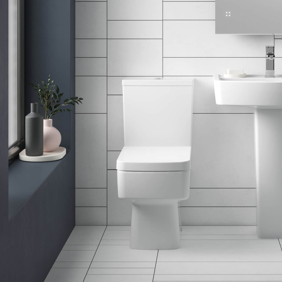 White Nuie Bliss semi-flush wall-mounted WC pan with open back and cistern, measuring 374x610mm, by Tuskan Tiles.