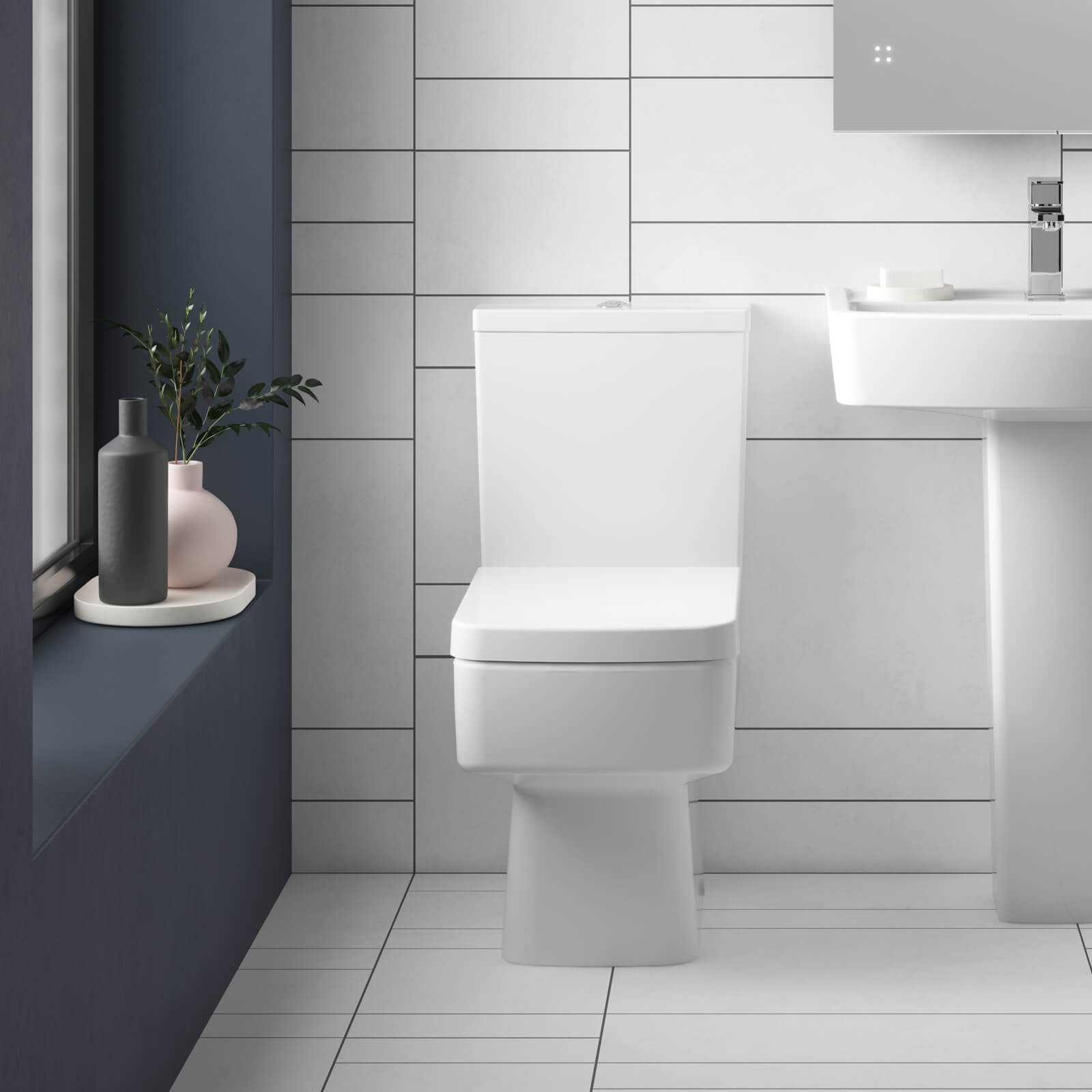 White Nuie Bliss semi-flush wall-mounted WC pan with open back and cistern, measuring 374x610mm, by Tuskan Tiles.