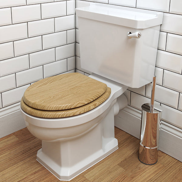 White close-coupled traditional WC pan with cistern, open back, measuring 520x690mm, by Tuskan Tiles.