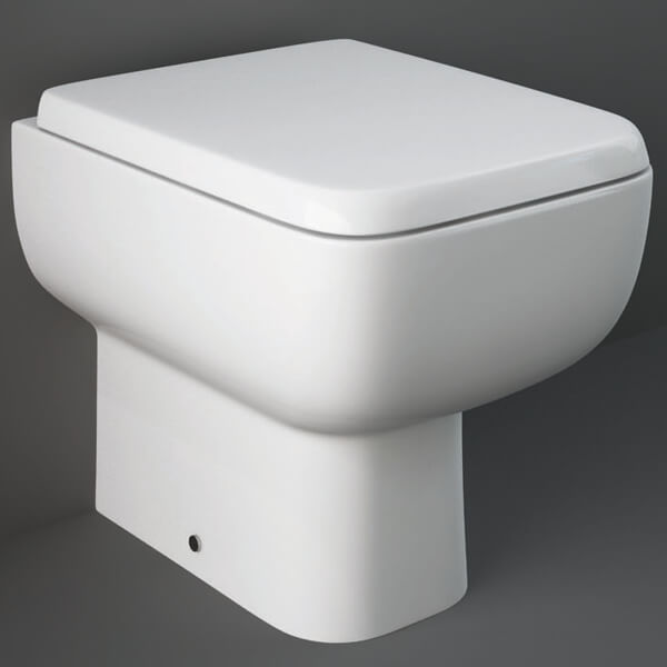 White RAK Series-600 back-to-wall toilet pan with soft-close seat, measuring 350x490mm, from Tuskan Tiles.