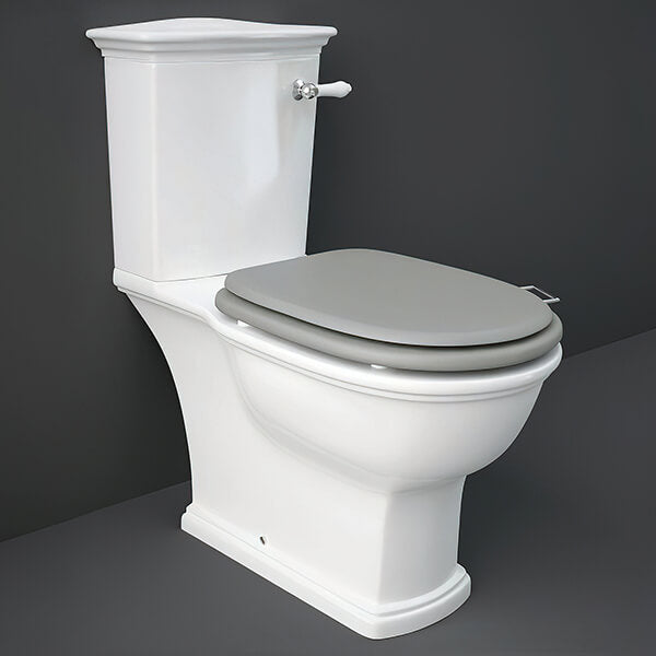 Tuskan Tiles RAK Washington close coupled WC pan with cistern and soft close wooden seat, white ceramic bathroom fixture.
