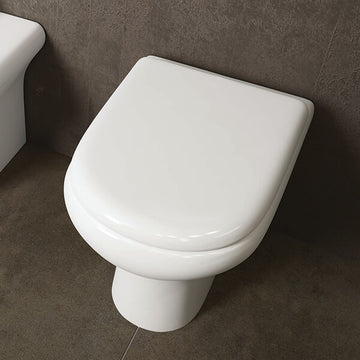 White RAK compact back-to-wall WC pan with soft-close seat, measuring 370x510mm, installed in a modern bathroom setting.