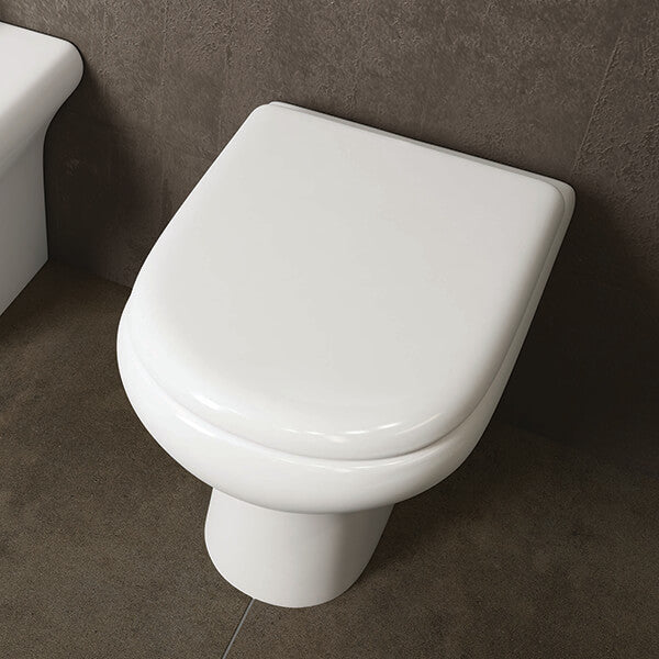White RAK compact back-to-wall WC pan with soft-close seat, measuring 370x510mm, installed in a modern bathroom setting.