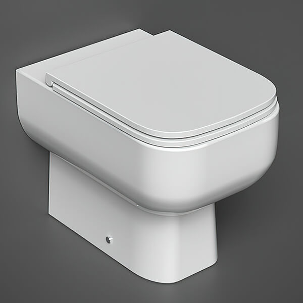 White RAK Series-600 back-to-wall WC pan with soft-close seat, 350x490mm, shown with the Tuskan Tiles brand.