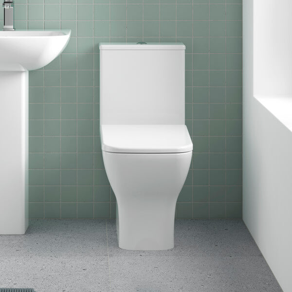 Nuie Ava closed coupled rimless toilet with cistern and soft close seat, 375 x 610mm, in a modern white bathroom setting