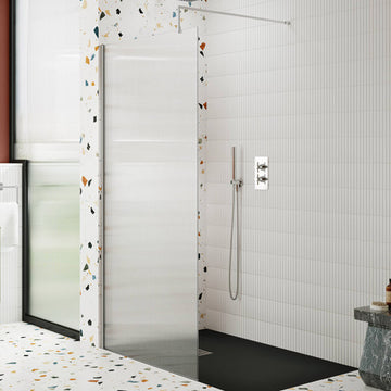 Hudson Reed fluted glass walk-in shower screen with aluminium profile and support bar, installed in a modern wet room.