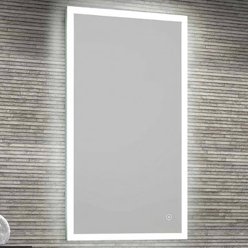 Rectangular LED mirror with border lighting, demister pad, and shaver socket by Tuskan Tiles, shown with illuminated border and reflective surface.