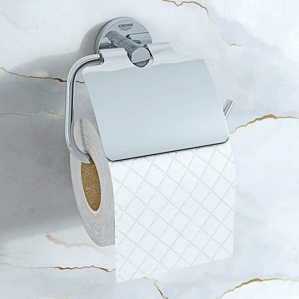 Chrome Grohe Essentials C-shaped toilet roll holder with cover, mounted on bathroom wall, in a modern chrome finish.