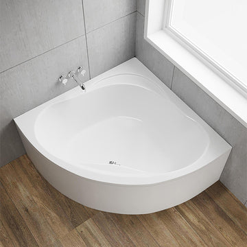 Trojan Laguna white corner bath with Lucite acrylic encapsulated baseboard, featuring smooth edges and a modern design.
